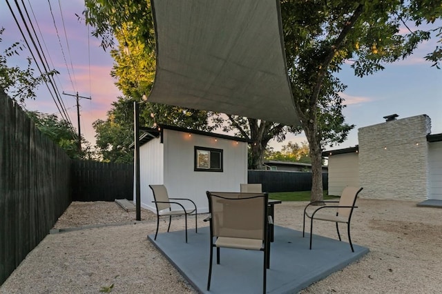 view of patio terrace at dusk