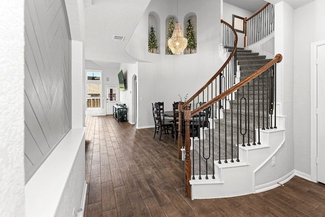 stairs with hardwood / wood-style floors and a textured ceiling