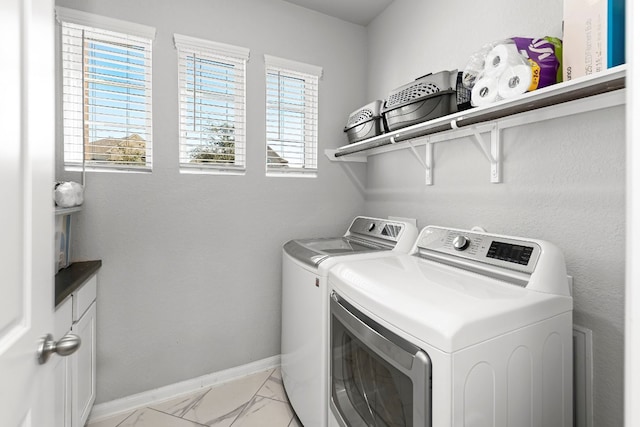 clothes washing area featuring washer and clothes dryer