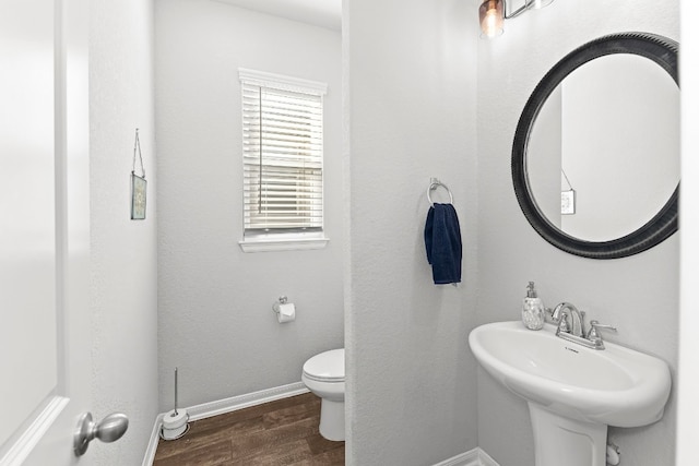 bathroom featuring sink, toilet, and hardwood / wood-style flooring