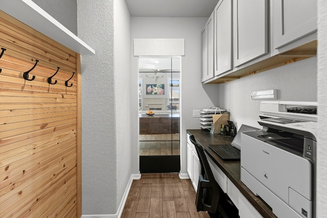 kitchen with dark hardwood / wood-style floors and white cabinetry