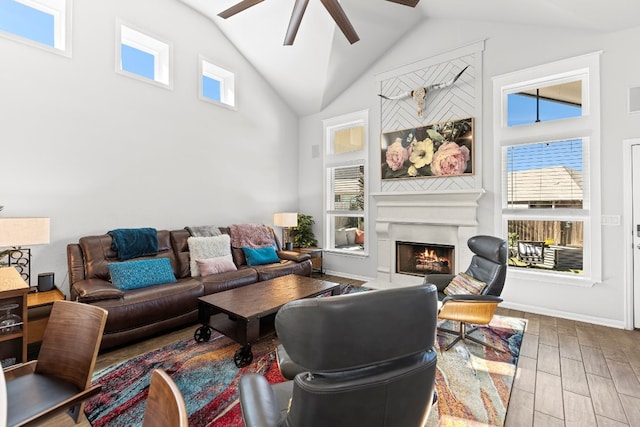 living room featuring hardwood / wood-style floors, ceiling fan, and high vaulted ceiling