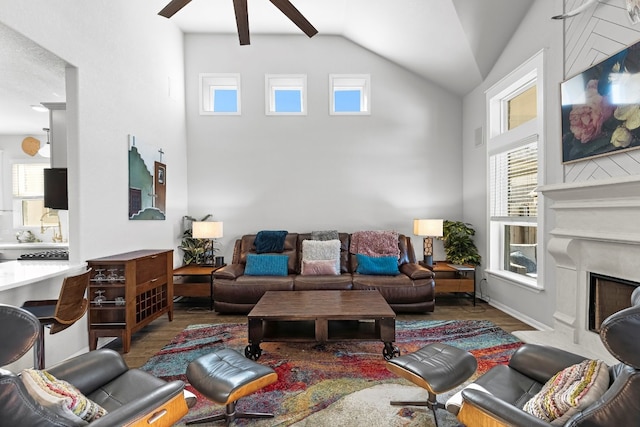 living room featuring lofted ceiling, hardwood / wood-style flooring, ceiling fan, and a healthy amount of sunlight