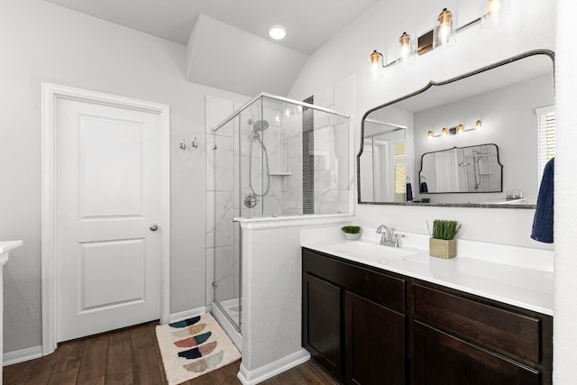 bathroom with lofted ceiling, hardwood / wood-style floors, vanity, and an enclosed shower