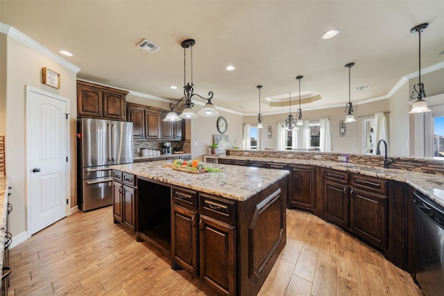 kitchen featuring dark brown cabinets, light wood-type flooring, black dishwasher, and stainless steel refrigerator