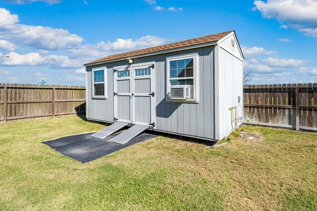 view of outdoor structure with a yard and cooling unit