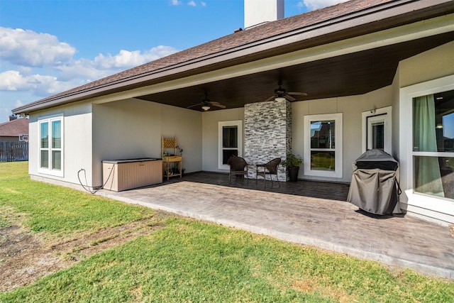 back of house with ceiling fan, a patio area, and a yard