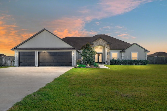 view of front of home featuring a yard and a garage