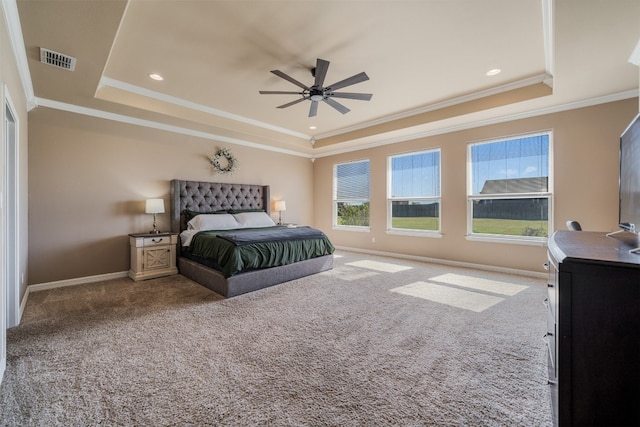 bedroom with carpet floors, a tray ceiling, ceiling fan, and ornamental molding