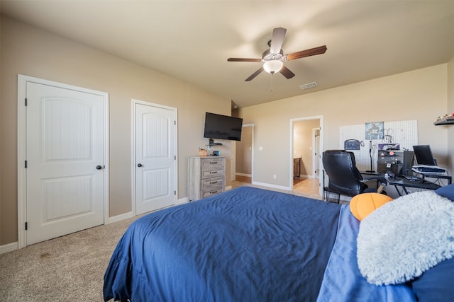 carpeted bedroom featuring ceiling fan and connected bathroom