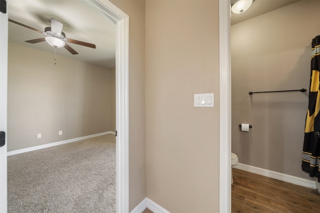 bathroom with hardwood / wood-style floors, ceiling fan, and toilet