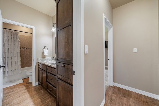 full bathroom with shower / bathtub combination with curtain, vanity, toilet, and wood-type flooring