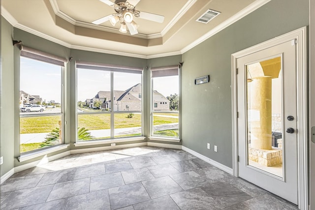 interior space with crown molding, plenty of natural light, a raised ceiling, and ceiling fan