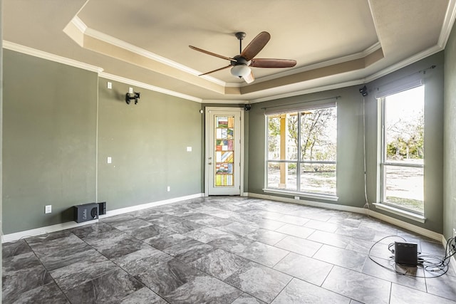 spare room with crown molding, ceiling fan, and a tray ceiling