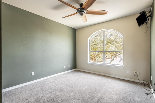 spare room featuring ceiling fan and carpet