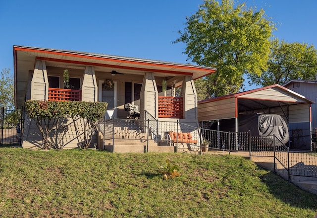 view of front of house featuring ceiling fan, covered porch, a front yard, and a carport