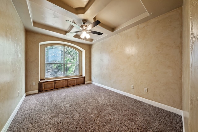 unfurnished room with carpet, a raised ceiling, and ceiling fan