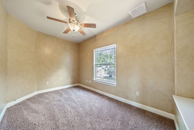 carpeted spare room featuring ceiling fan