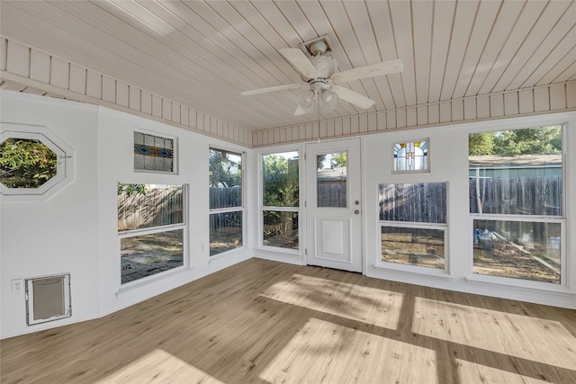 unfurnished sunroom with ceiling fan and wooden ceiling