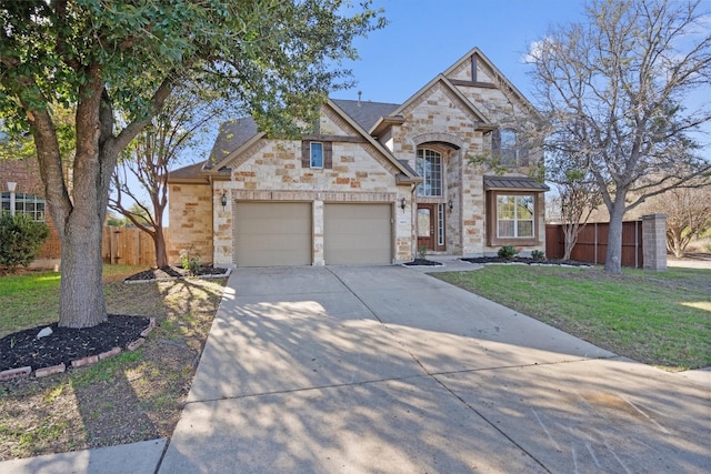 view of front of property with a garage and a front lawn