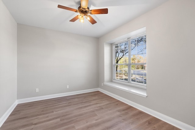 spare room with hardwood / wood-style floors and ceiling fan