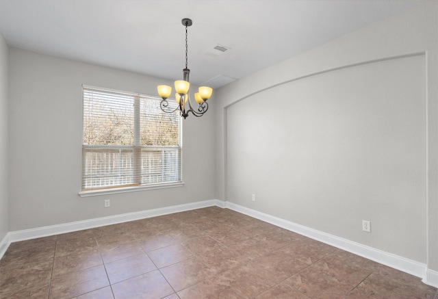 unfurnished room with tile patterned floors and an inviting chandelier