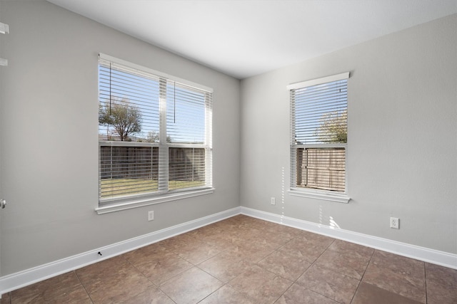 tiled empty room with a healthy amount of sunlight