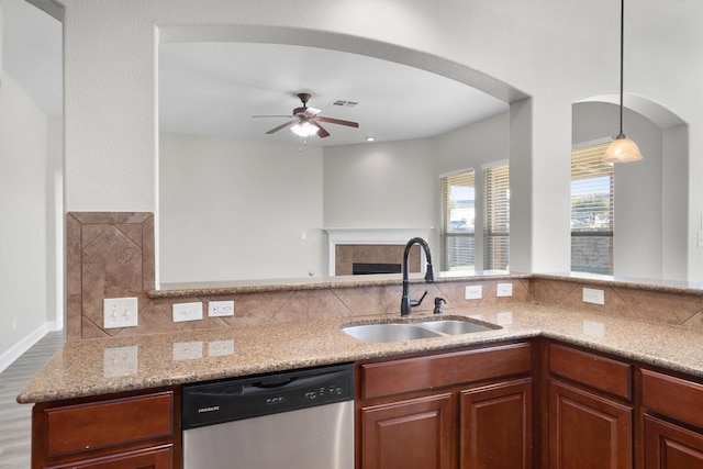 kitchen featuring sink, stainless steel dishwasher, ceiling fan, decorative light fixtures, and wood-type flooring