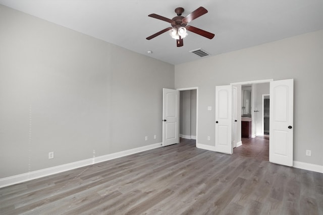 unfurnished bedroom with ceiling fan and wood-type flooring