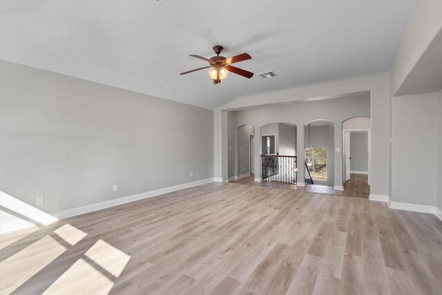 unfurnished living room featuring light hardwood / wood-style flooring, ceiling fan, and lofted ceiling