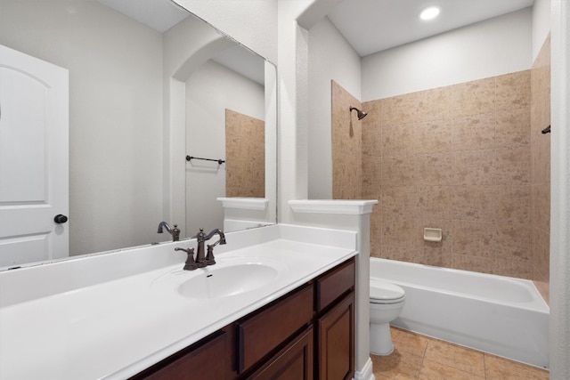 full bathroom featuring tile patterned floors, vanity, toilet, and tiled shower / bath