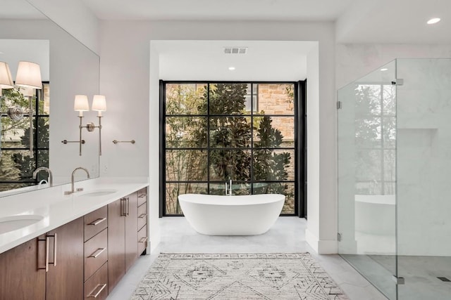 bathroom with independent shower and bath, vanity, and expansive windows