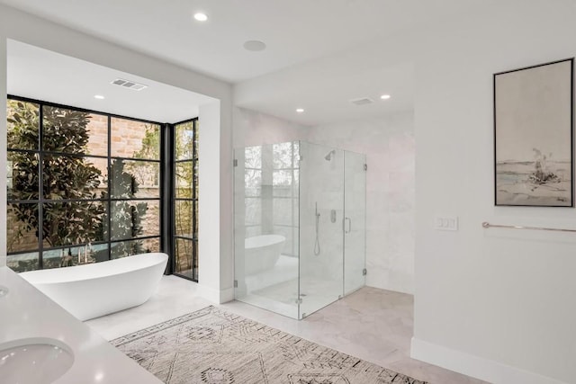 bathroom with floor to ceiling windows, plus walk in shower, and sink