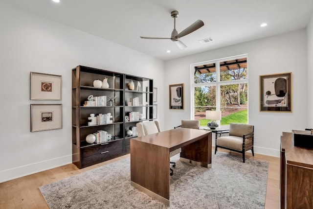 office space with light hardwood / wood-style floors and ceiling fan