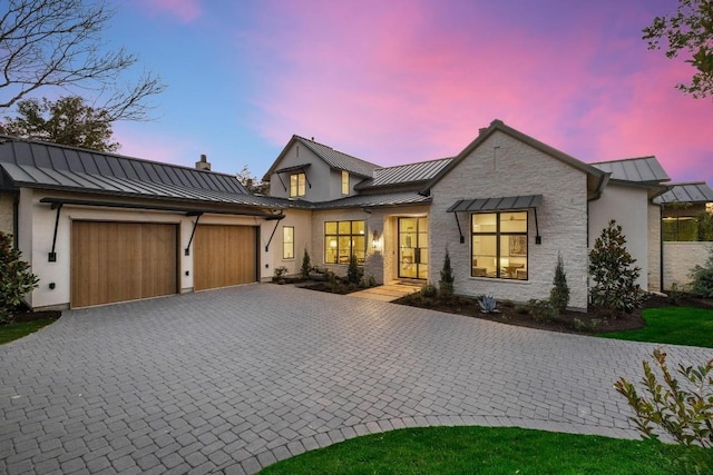 modern farmhouse style home featuring a garage