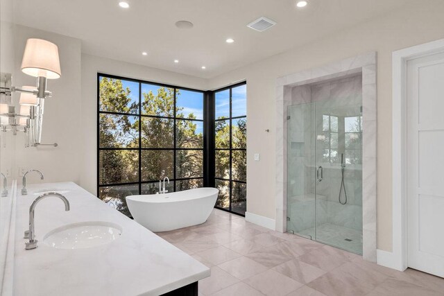 4312 Amarra Dr, Austin, TX 78735 - bathroom featuring visible vents, double vanity, a freestanding tub, a sink, and a stall shower