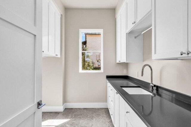 4312 Amarra Dr, Austin, TX 78735 - kitchen featuring white cabinetry, a sink, and dark countertops