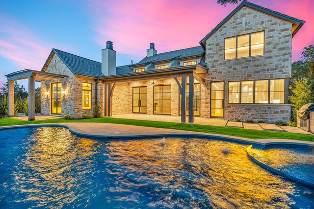 4312 Amarra Dr, Austin, TX 78735 - rear view of house featuring stone siding, a chimney, a patio, and an outdoor pool
