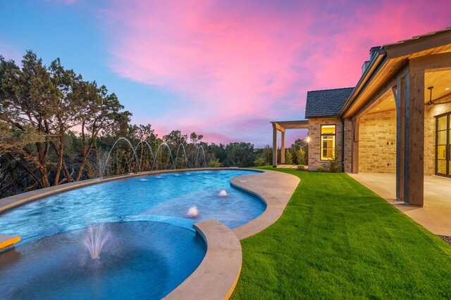 4312 Amarra Dr, Austin, TX 78735 - pool at dusk with a lawn, an outdoor pool, and a patio