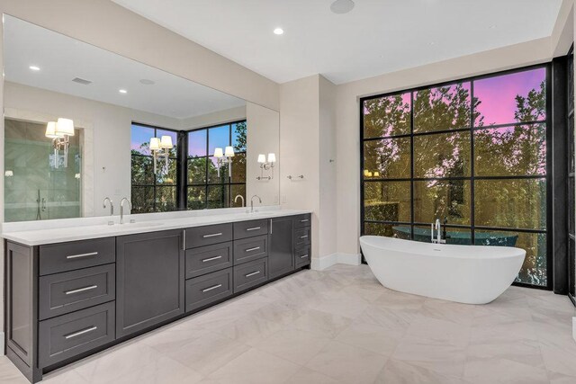 4312 Amarra Dr, Austin, TX 78735 - bathroom with a freestanding tub, double vanity, baseboards, and a sink