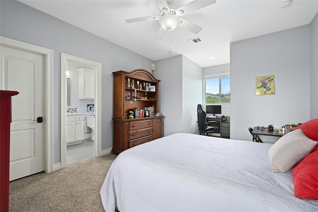 bedroom with connected bathroom, light carpet, and ceiling fan