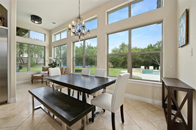 12920 Zen Gardens Way, Austin, TX 78732 - dining space featuring light tile patterned floors, a chandelier, and a high ceiling
