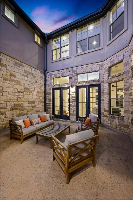 patio terrace at dusk with outdoor lounge area and french doors