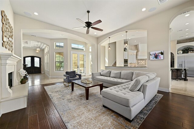 12920 Zen Gardens Way, Austin, TX 78732 - living room with arched walkways, wood-type flooring, a ceiling fan, recessed lighting, and french doors