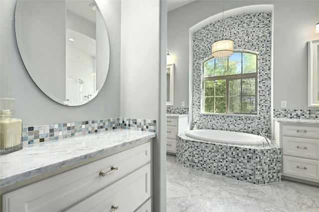 bathroom with tiled bath and vanity