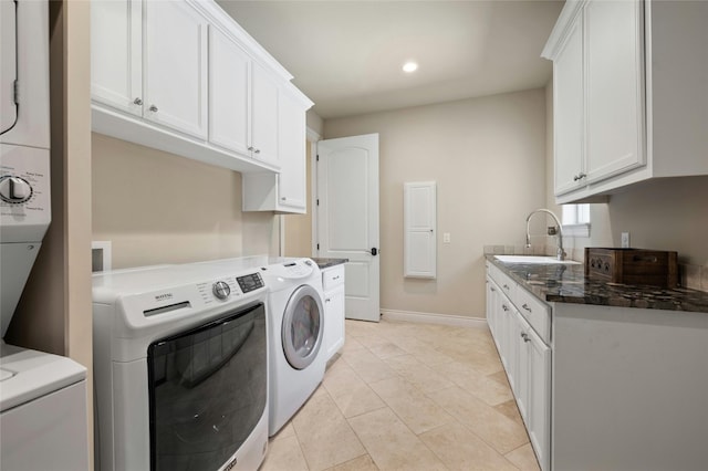 washroom with washer and dryer, light tile patterned floors, cabinets, and sink