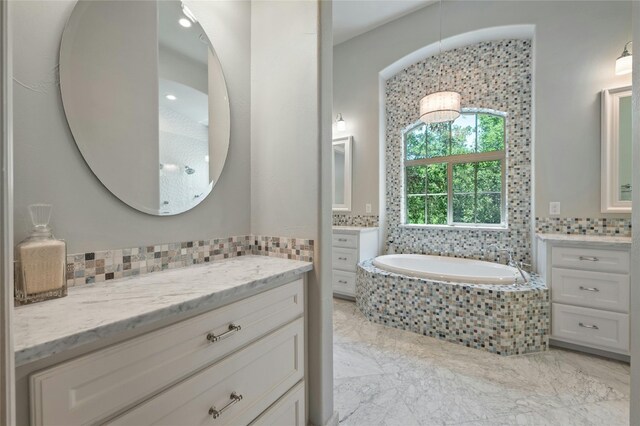 12920 Zen Gardens Way, Austin, TX 78732 - bathroom with two vanities, a bath, and marble finish floors