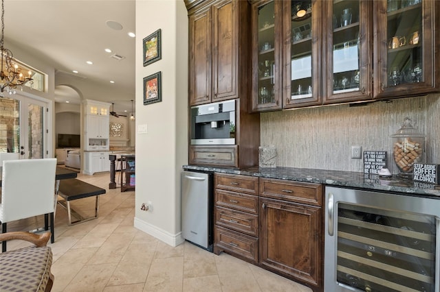 12920 Zen Gardens Way, Austin, TX 78732 - bar with wine cooler, arched walkways, backsplash, a chandelier, and light tile patterned floors