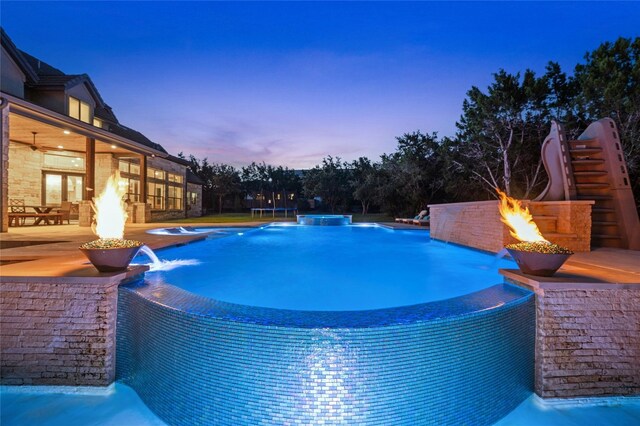 12920 Zen Gardens Way, Austin, TX 78732 - pool at dusk with a patio, an outdoor fire pit, and a pool with connected hot tub