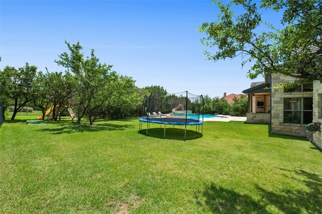 12920 Zen Gardens Way, Austin, TX 78732 - view of grassy yard with a trampoline